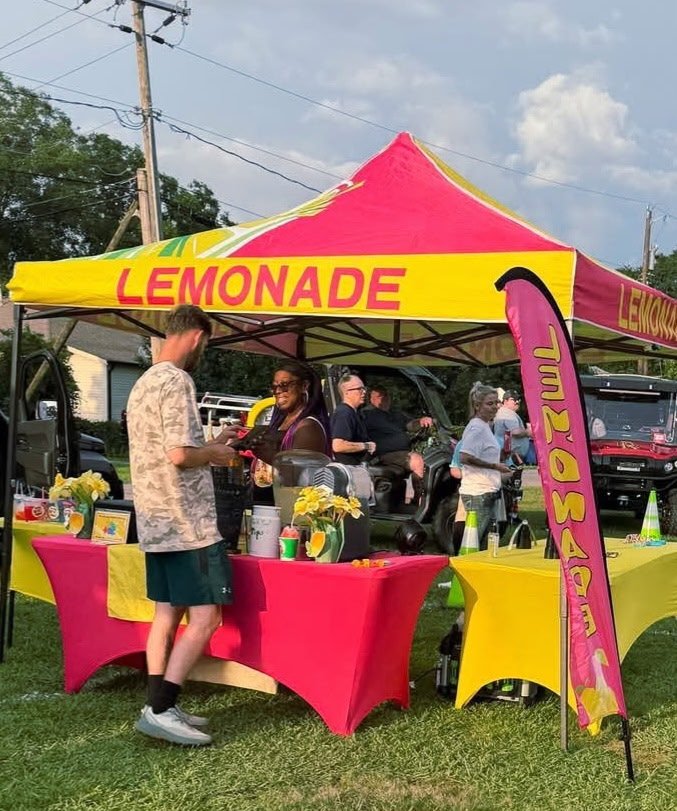 Legendary Lemonades event tent with pink and yellow branding