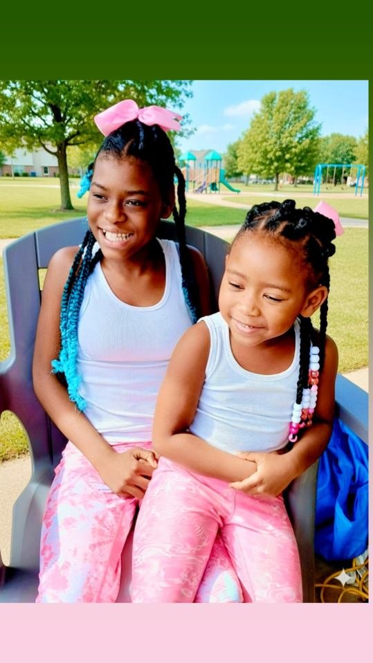 Legend and Grace sitting together at a playground